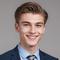 Small_a-young-man-in-a-suit-and-tie-smiling-free-photo